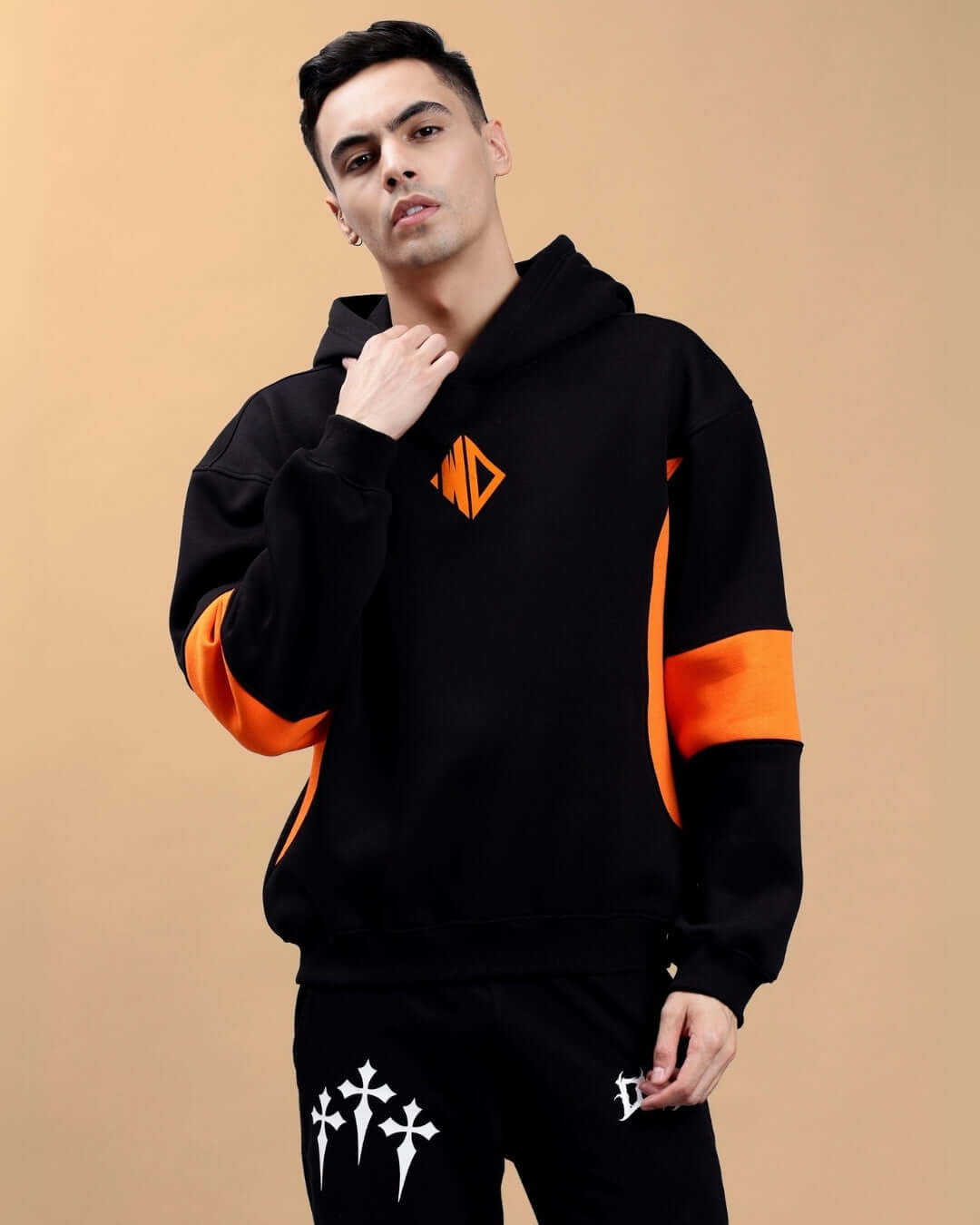 Alt Tag: Stylish WD Gorpcore colorblock hoodie in black and orange with unique design, modeled by a person.