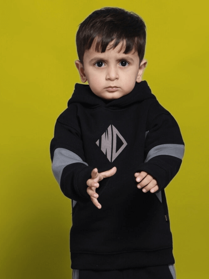 Child wearing WD Gorbcore Fleece Hoodie for Boys Girls Black Grey against yellow background