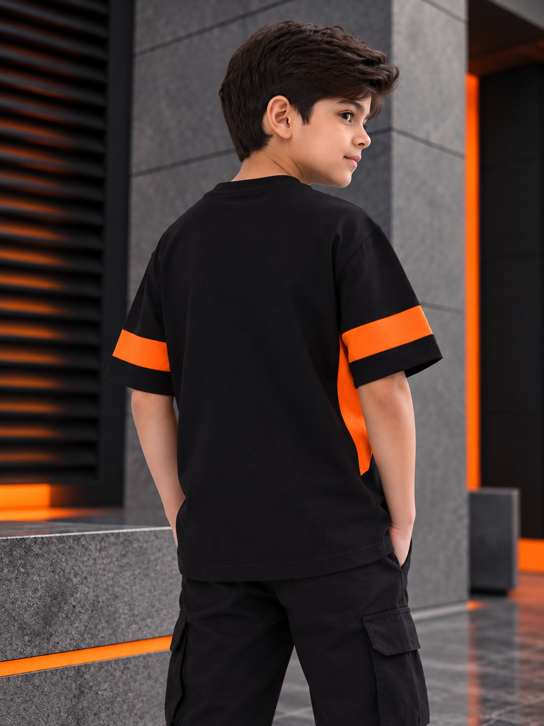 WD GORBCORE T-SHIRT FOR BOYS GIRLS BLACK ORANGE worn by boy, back view, stylish urban outdoor look