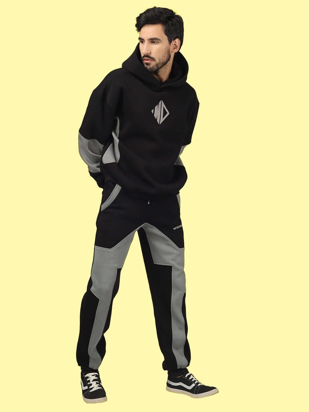 Model wearing WD GORBCORE colorblock co-ord set in black and grey, showcasing Gorpcore streetwear with a contemporary design.