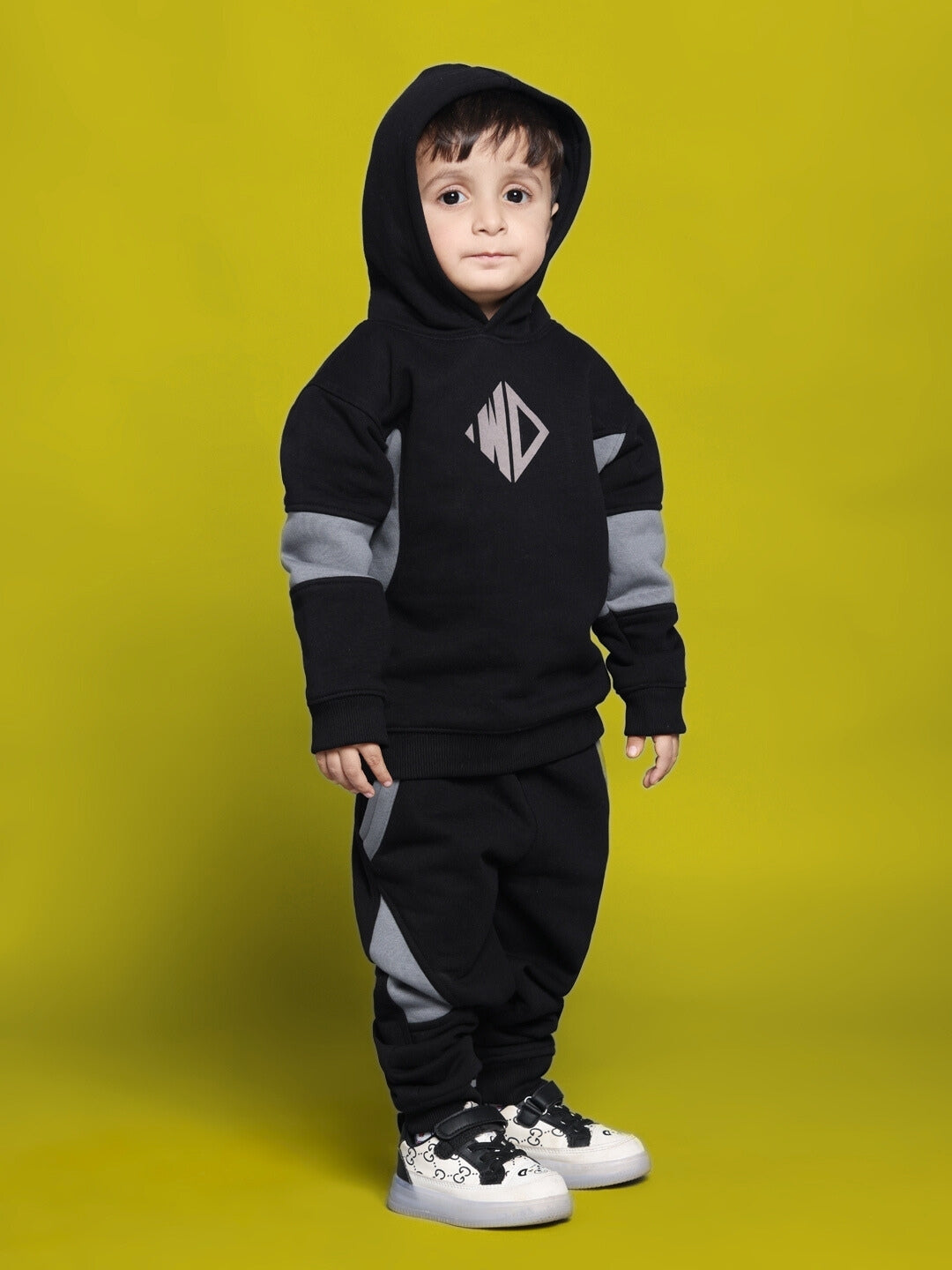 WD GORBCORE FLEECE COLORBLOCK PANT FOR BOYS GIRLS BLACK with black and grey design on child in sneakers