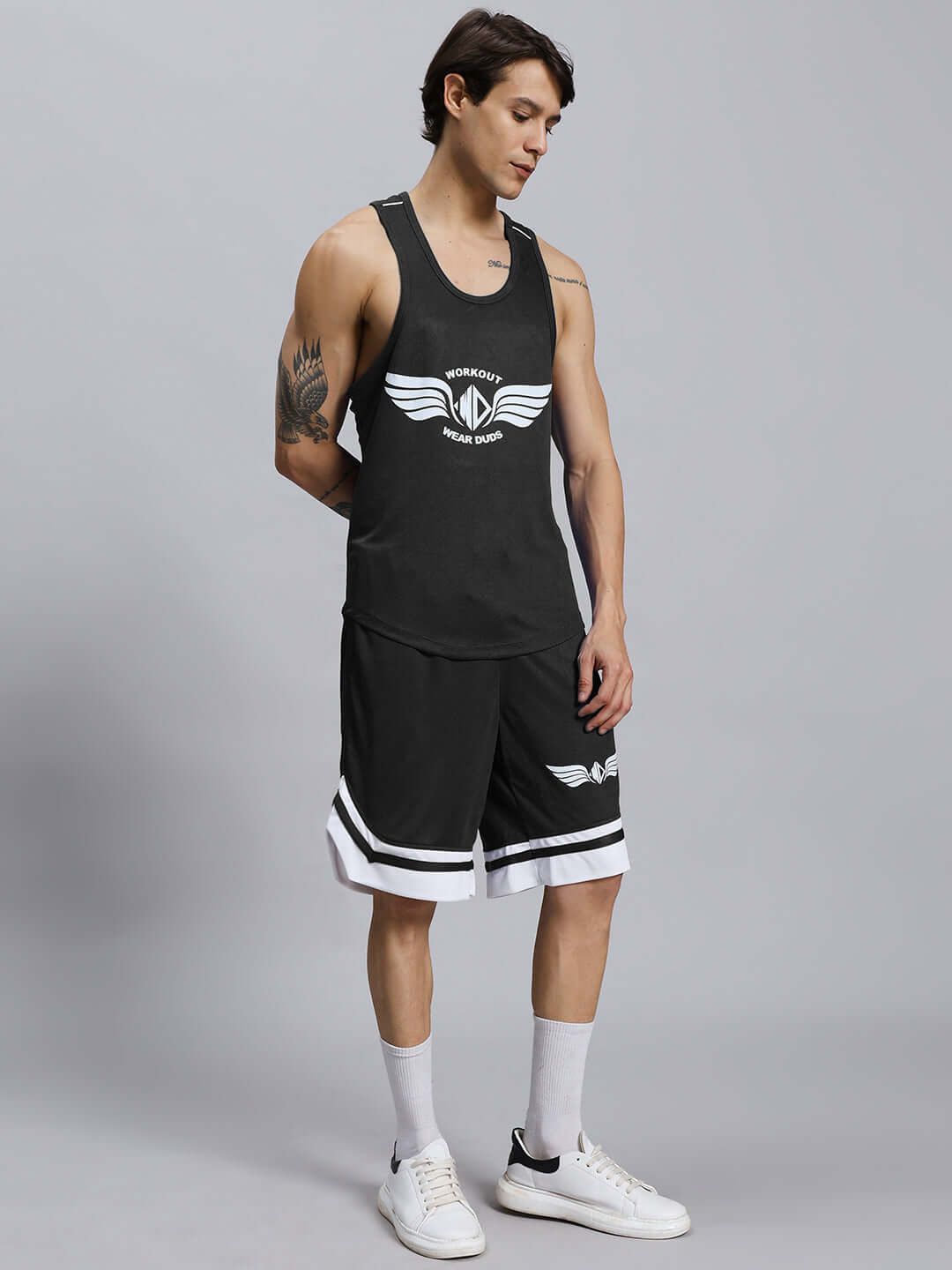 Man wearing WD WINGS GYM CO-ORD SET MEN BLACK, a stylish black athletic outfit for high-performance workouts, featuring bold "Wings" design.
