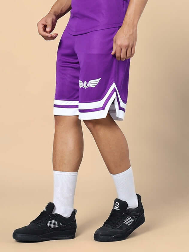 Man wearing WD WINGS REGULAR FIT SHORTS PURPLE with white socks and black sneakers showcasing casual style.