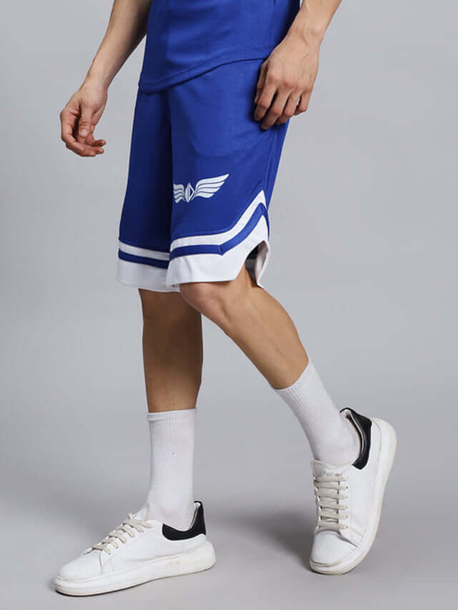 Man wearing WD WINGS REGULAR FIT SHORTS ROYAL BLUE with sneakers, showing stylish and comfortable fit for activewear.