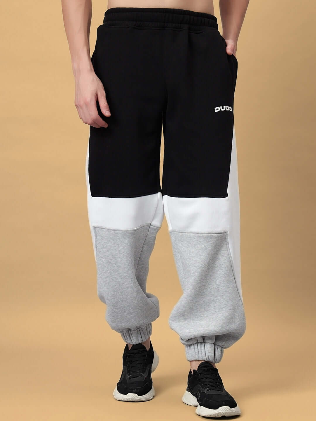 Black and grey colorblock joggers for men, made to order by DUDS, with customizable size options.