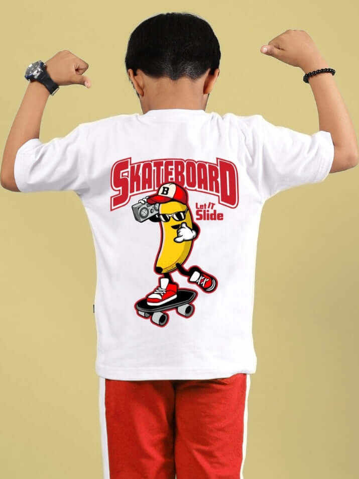 Boy wearing the SKATER BANANA T-SHIRT FOR BOYS & GIRLS WHITE with a skateboarding banana graphic.