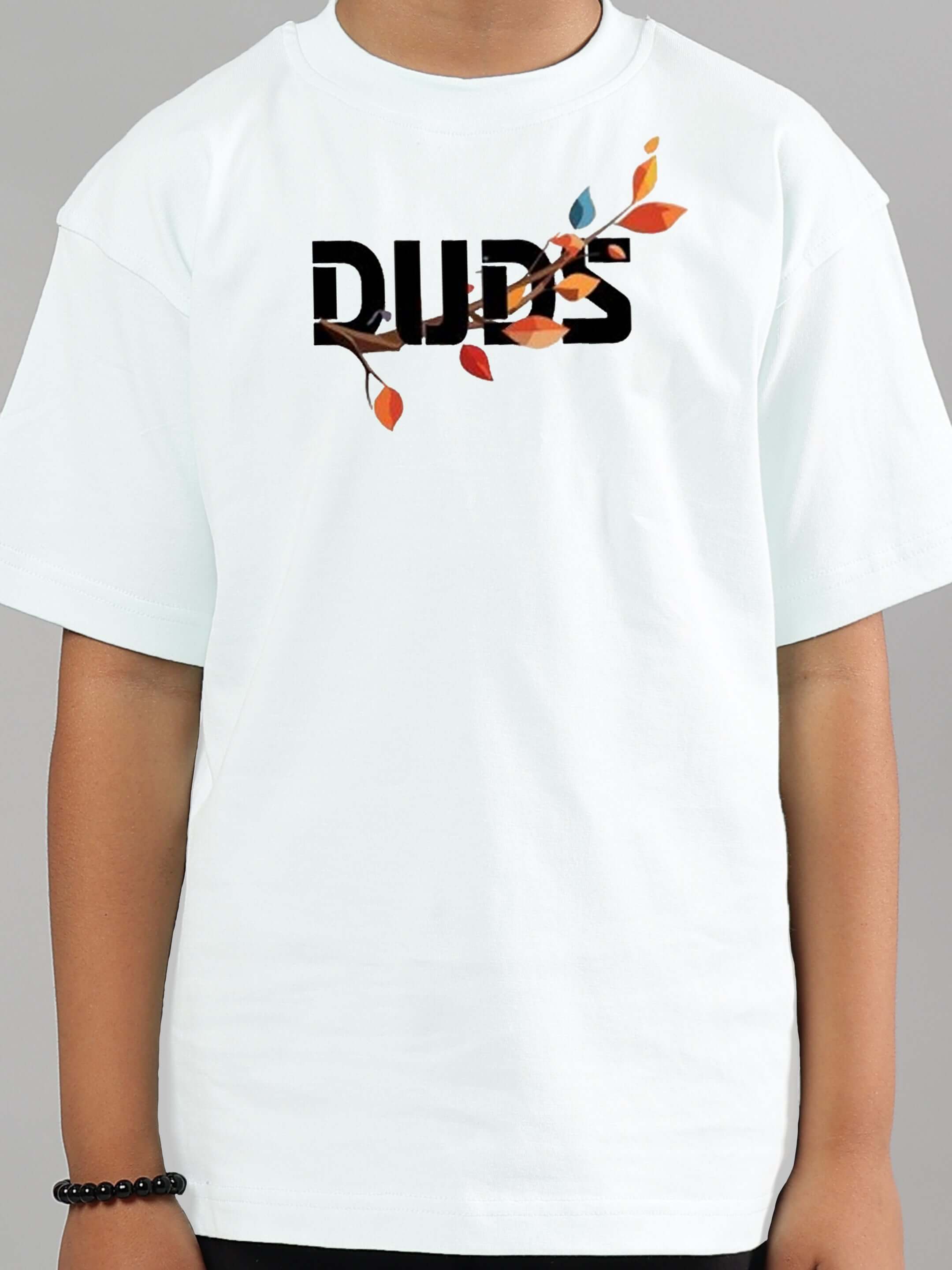 Child wearing white DUDS T-shirt with a colorful leaf design, showcasing the Hedwig co-ord for boys and girls.