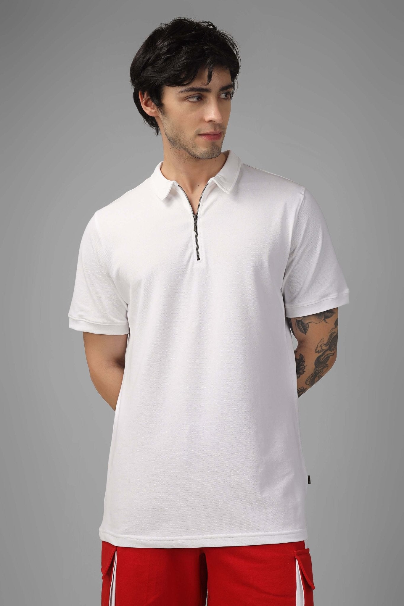 Model wearing red shorts and ZIPPER POLO NECK COTTON T-SHIRT WHITE with front zipper, showcasing a stylish and modern look.