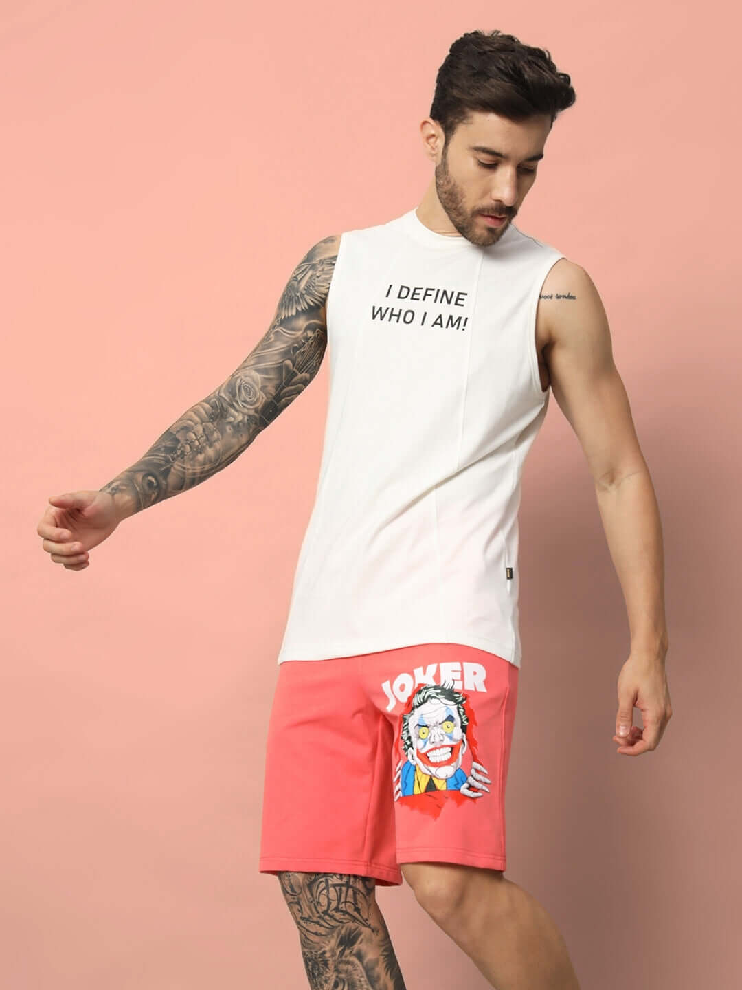 Man wearing WHO I AM GYM T-SHIRT OFF WHITE with Joker shorts, showcasing confidence and bold graphic design