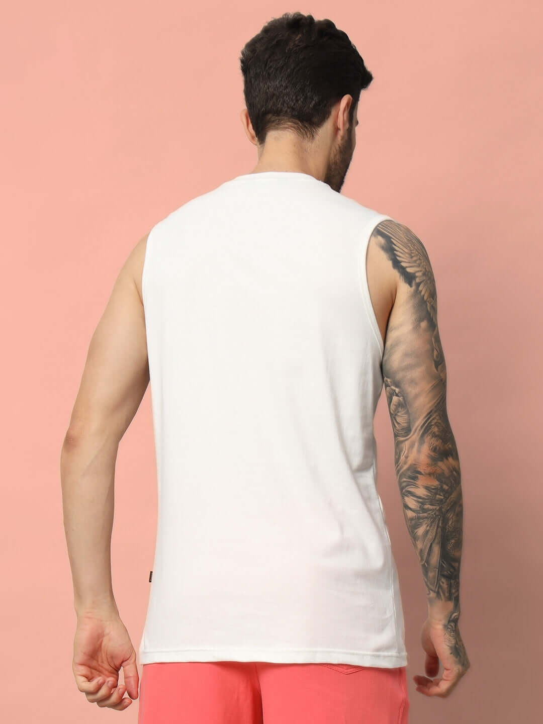 Back view of WHO I AM GYM T-SHIRT OFF WHITE worn by a man with tattooed arm, featuring muscle fit and breathable fabric.