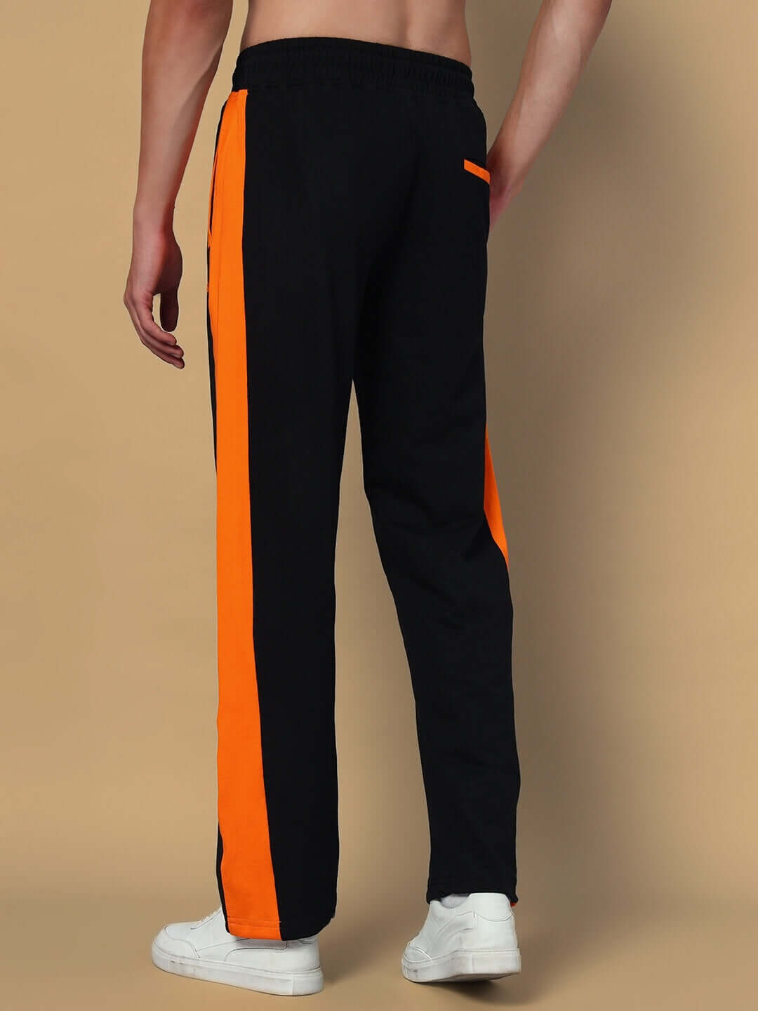 Back view of WHOPPER OVERSIZED CO-ORD SET ORANGE BLACK with orange stripes and white sneakers. Casual sporty style for relaxed comfort.
