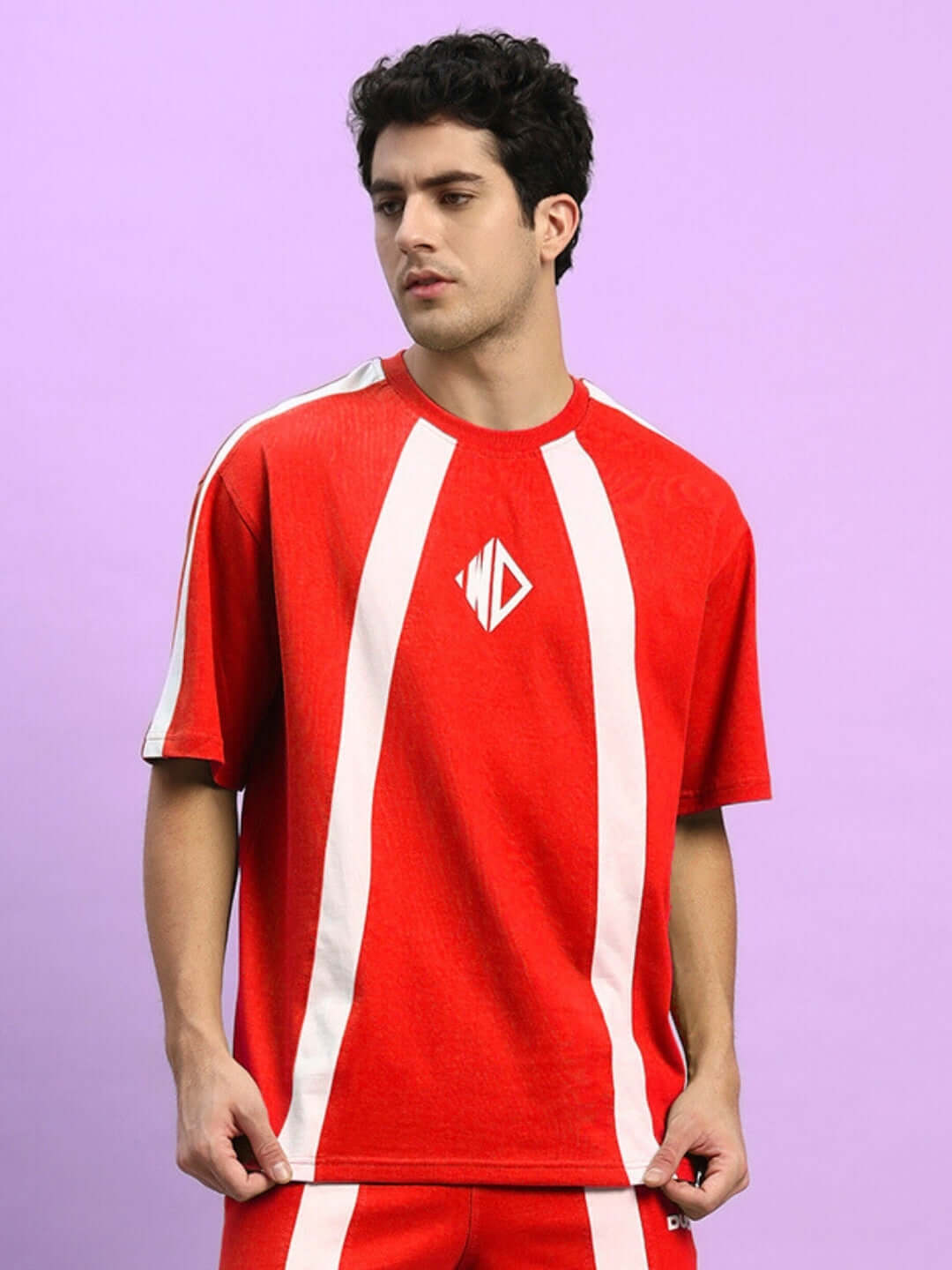 Model wearing red oversized T-shirt with white stripes, made from premium cotton French terry, by Color By Colours.