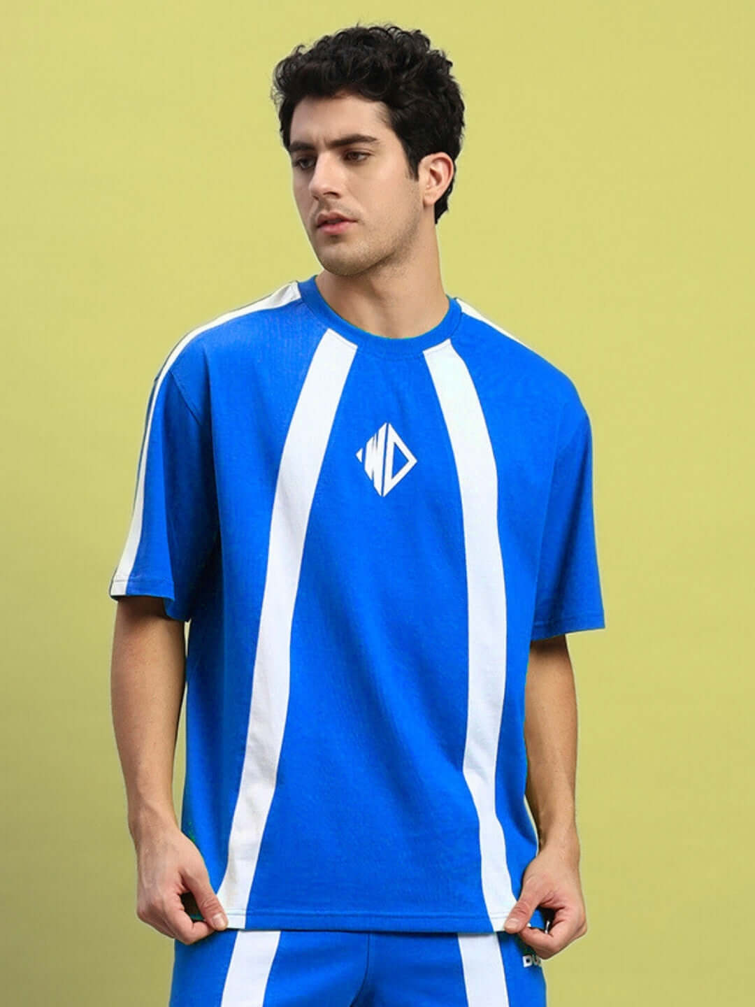 Model wearing WIDELINE over-sized T-shirt in royal blue with white stripes, made of premium cotton french terry, 220 GSM, by Color By Colours.