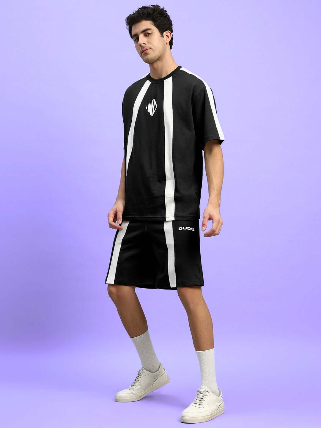 Model wearing WIDELINE Summer Co-Ord Set in black with white stripes, made from premium cotton and elastane, perfect for warm weather.