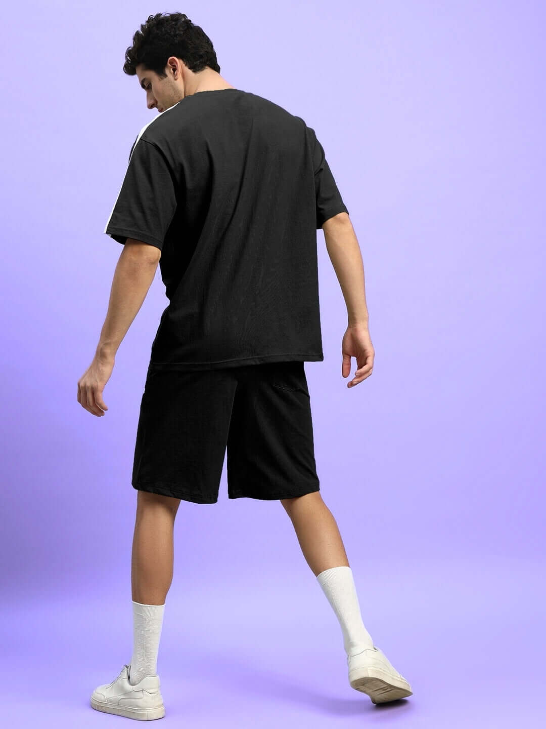 Man wearing black Wideline summer co-ord set showcasing premium cotton French terry fabric.