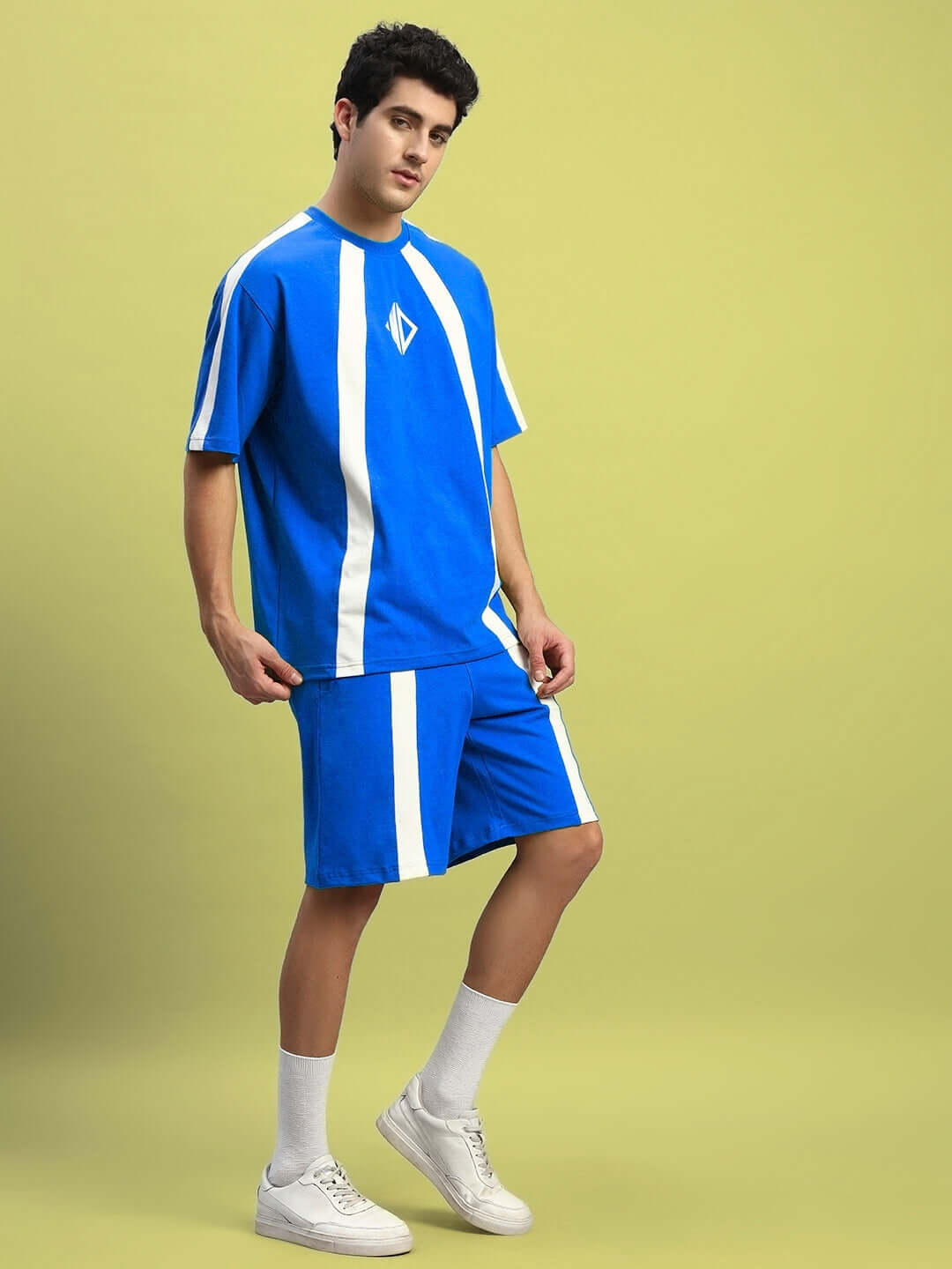Model wearing WIDELINE SUMMER CO-ORD SET ROYAL BLUE featuring oversized t-shirt and shorts, designed for casual style and comfort.