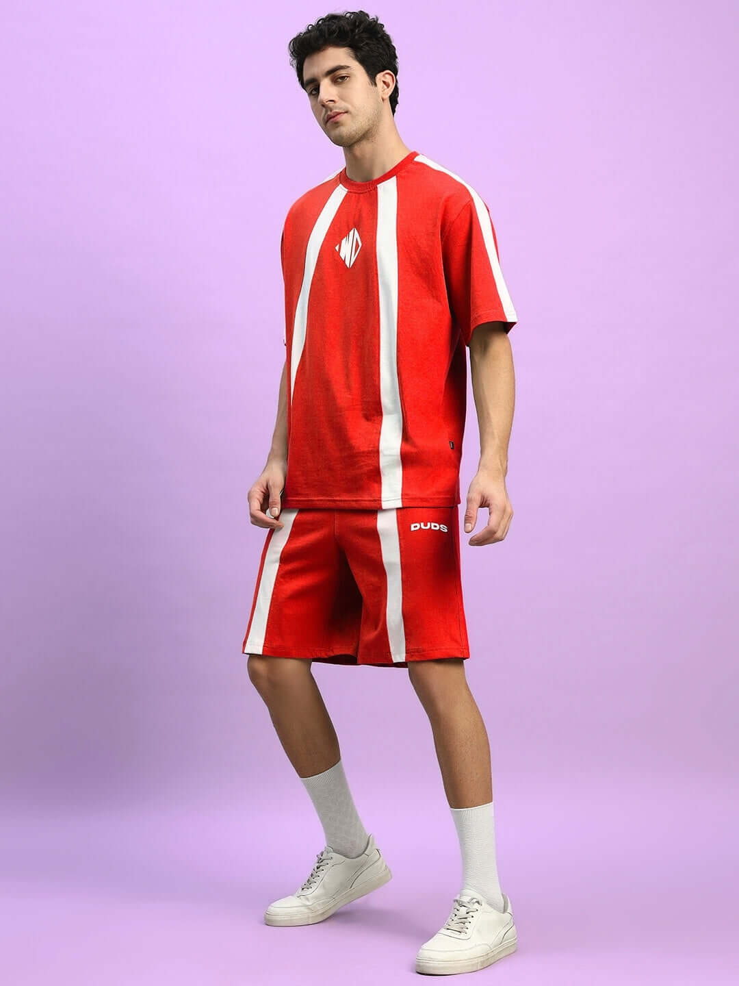 Model wearing WIDELINE SUMMER CO-ORD SET RED, featuring a relaxed fit t-shirt and shorts, perfect for stylish summer comfort.