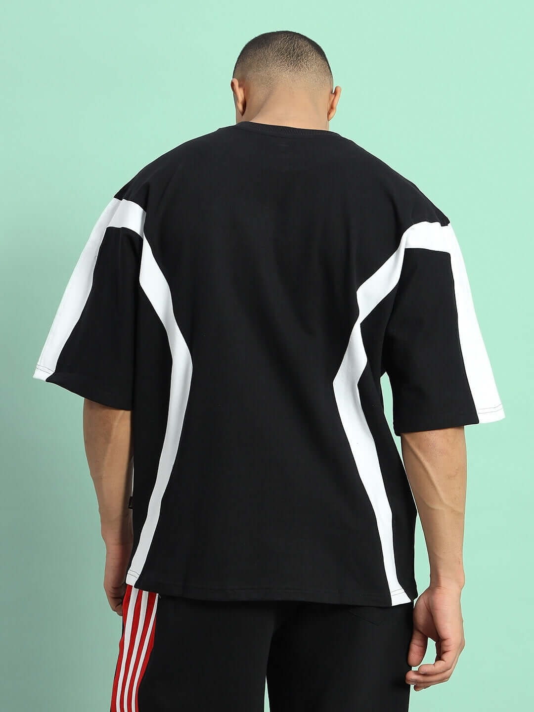 Back view of Wild Force oversized T-shirt in black and white, made from premium cotton French terry, ideal for casual wear.