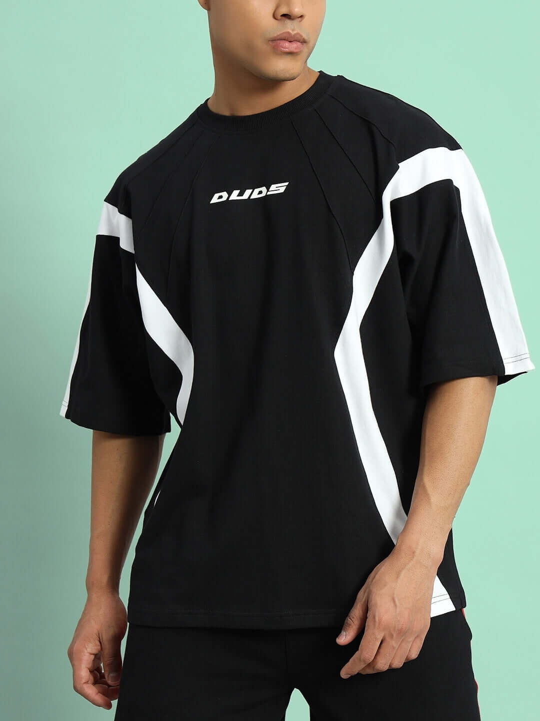 Model wearing Wild Force oversized black and white t-shirt made from premium cotton fabric with sporty design, by Color By Colours.