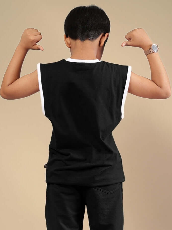 Child wearing WILD PLANET black t-shirt from DUDS, showcasing back view with arms flexed, available for boys and girls.