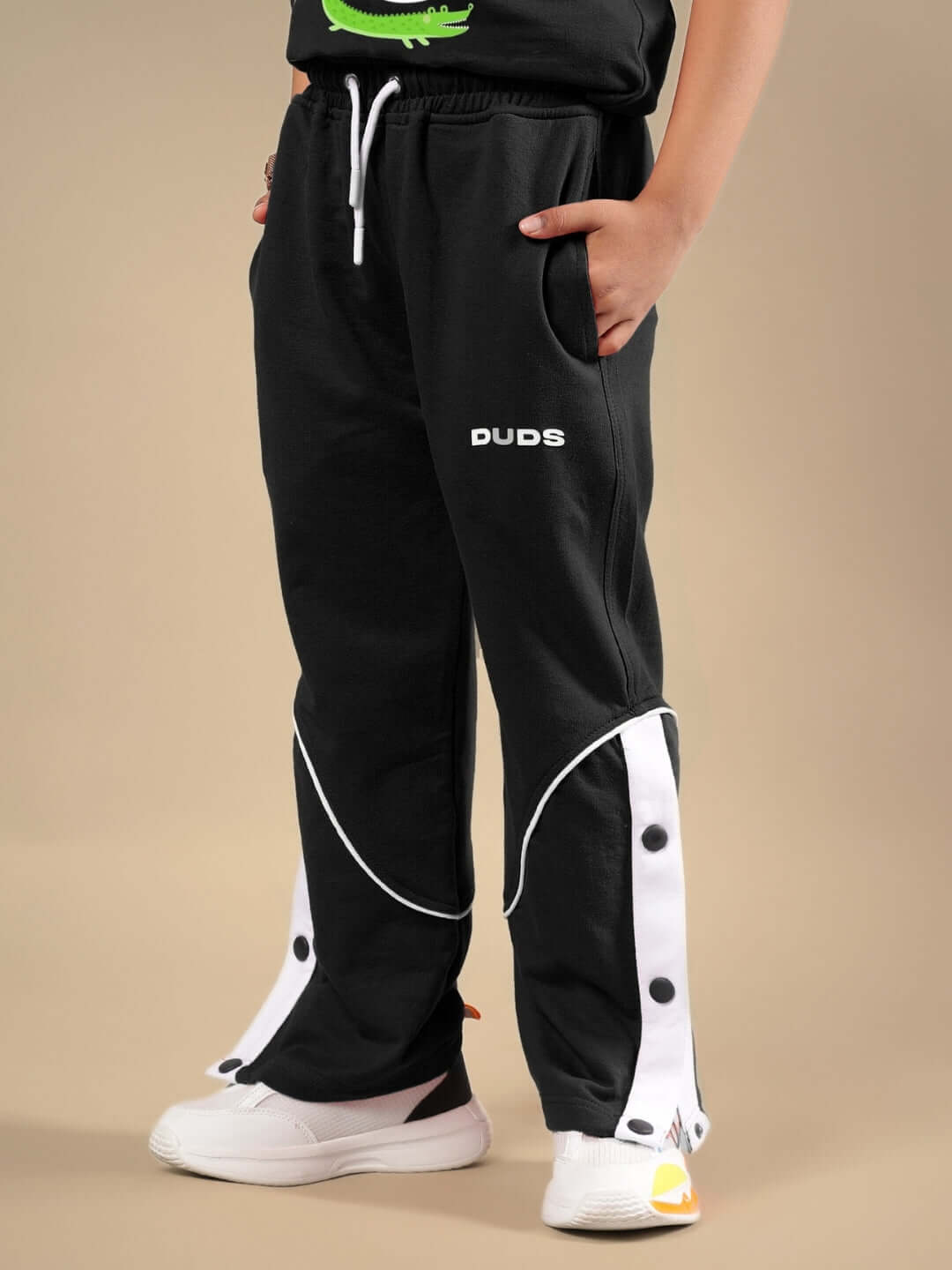 Child wearing Wild Planet black co-ord with logo print, showcasing comfortable and stylish design by DUDS for boys and girls.