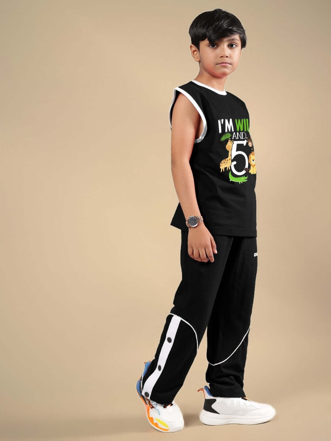 Child wearing Wild Planet black co-ord set, featuring jungle-themed graphics, perfect for boys and girls. Made-to-order by DUDS tailors.