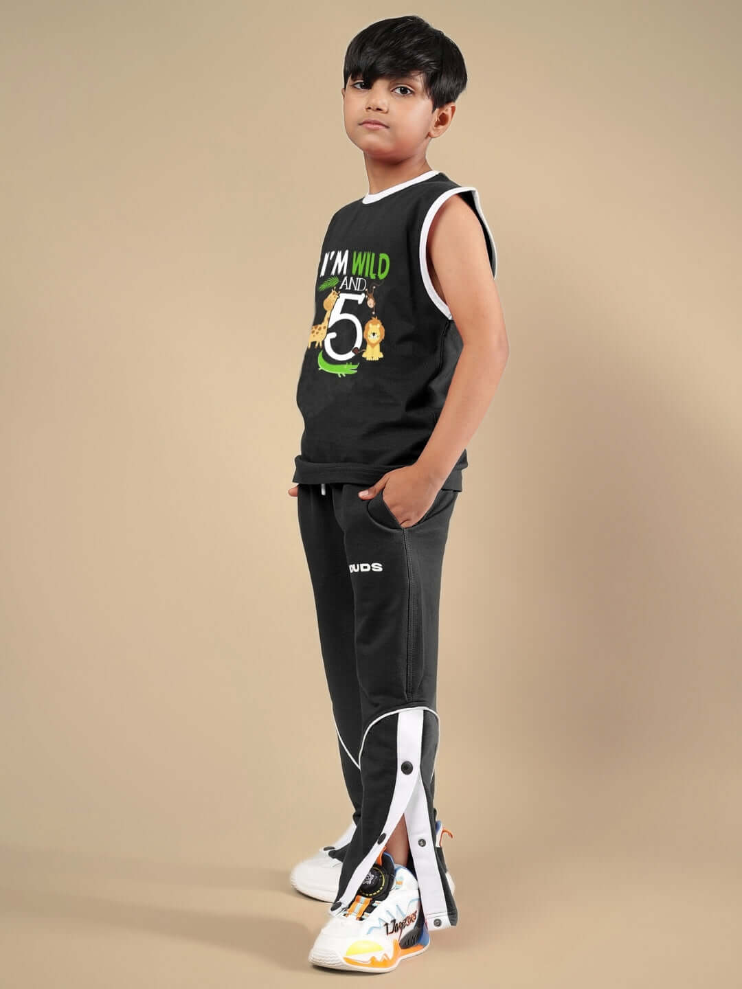 Child wearing Wild Planet black co-ord set, featuring sleeveless top and pants, made by DUDS tailors, perfect for boys and girls.