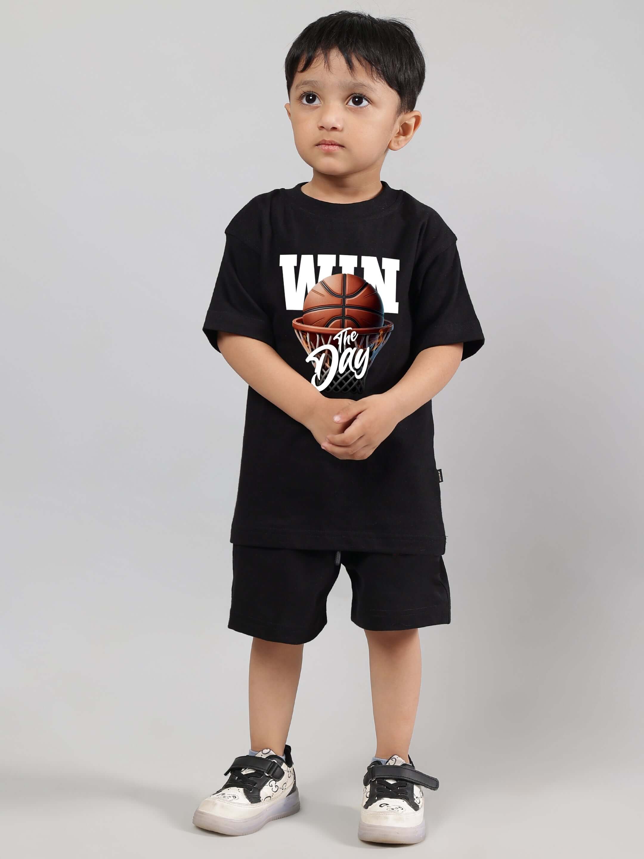 Young child wearing DUDS WIN DAY black co-ord outfit, featuring a basketball design. Suitable for boys and girls. Custom fit available.