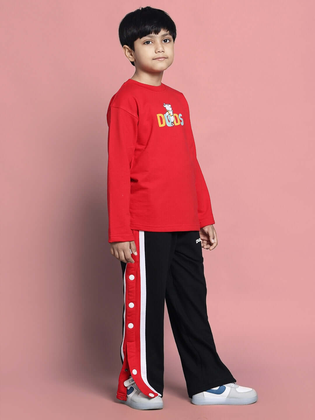 Child wearing WINNIE CO-ORD FOR BOYS GIRLS RED BLACK outfit, featuring red top and black pants with graphic design.
