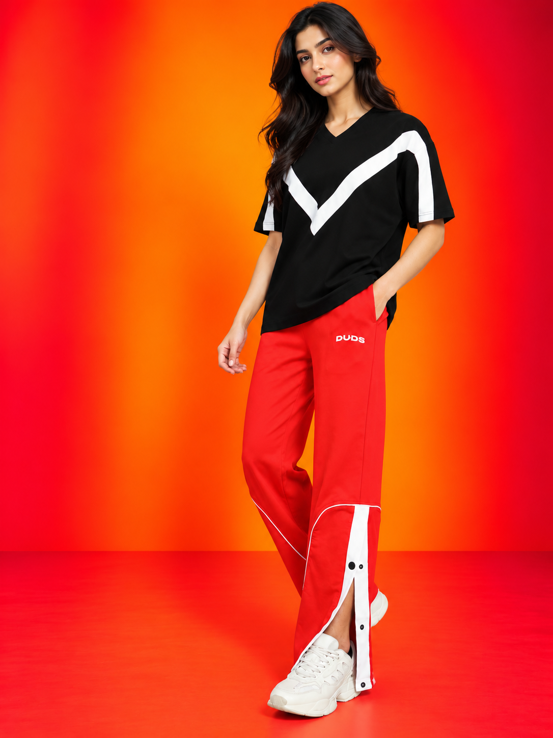 WOMEN ADROIT OVER-SIZED T-SHIRT BLACK styled with red track pants and sneakers for a casual chic look
