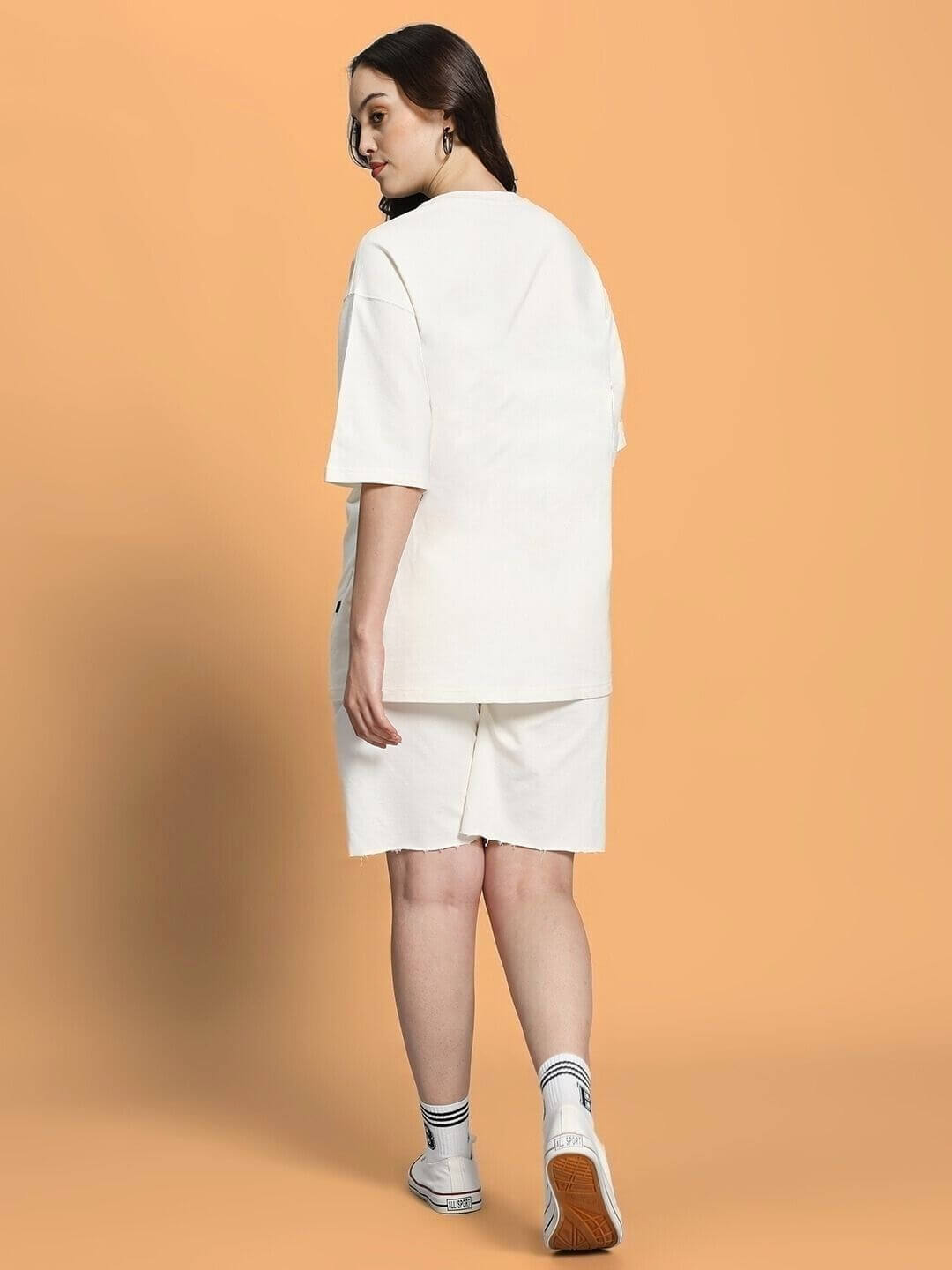 Back view of WOMEN CLOUD PRINTED CO-ORD SET OFF WHITE, showcasing relaxed-fit top and shorts set with soft cloud prints on off-white fabric.