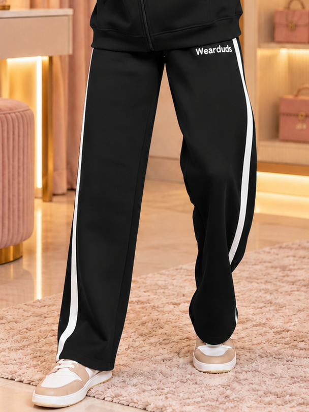 WOMEN RAPID STRIDE FLEECE JOGGER BLACK with white side stripes and Wearduds logo, styled with sneakers