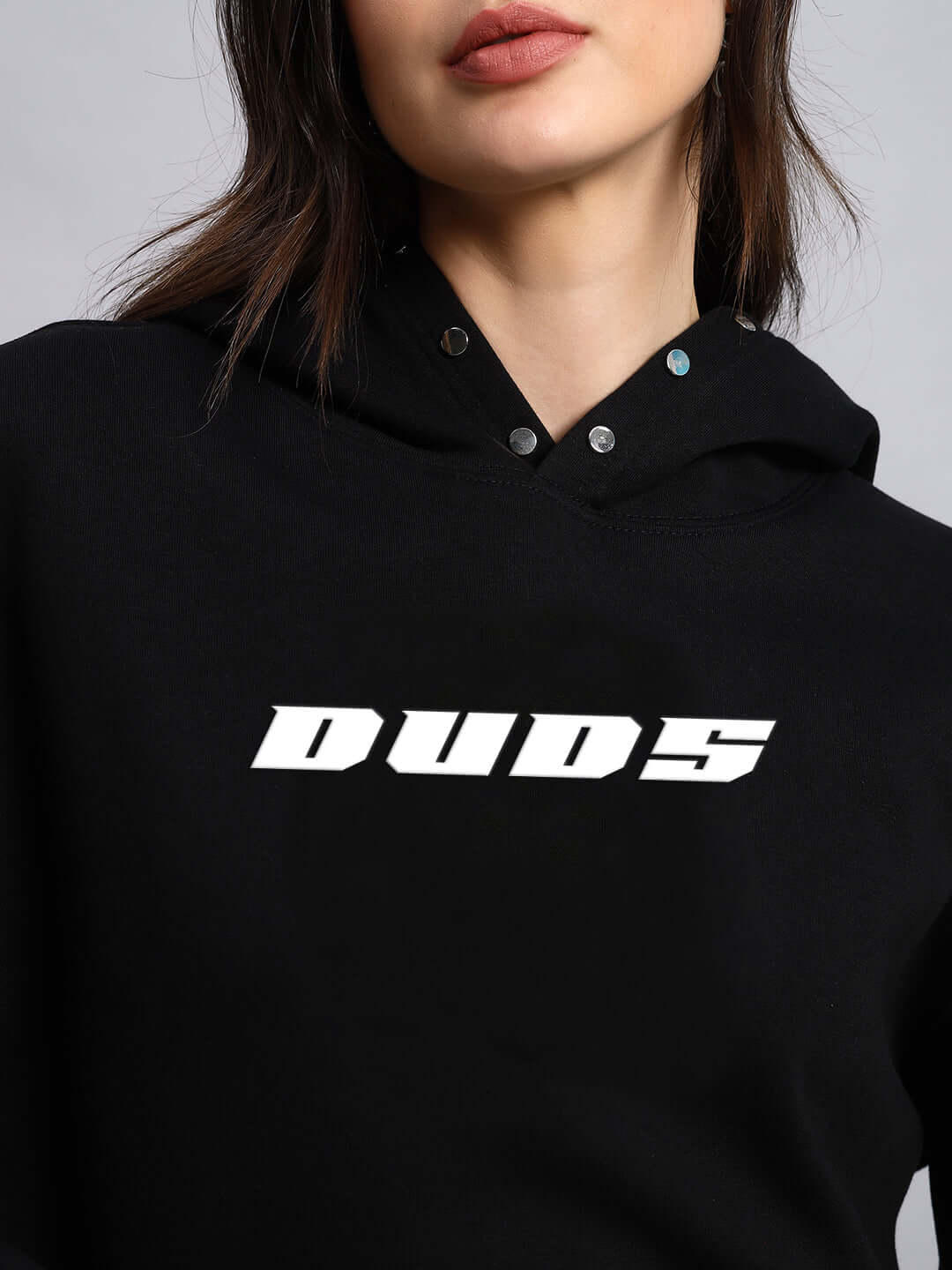 Close-up of WOMEN RIGID FLEECE HOODIE BLACK by DUDS shown on a model.