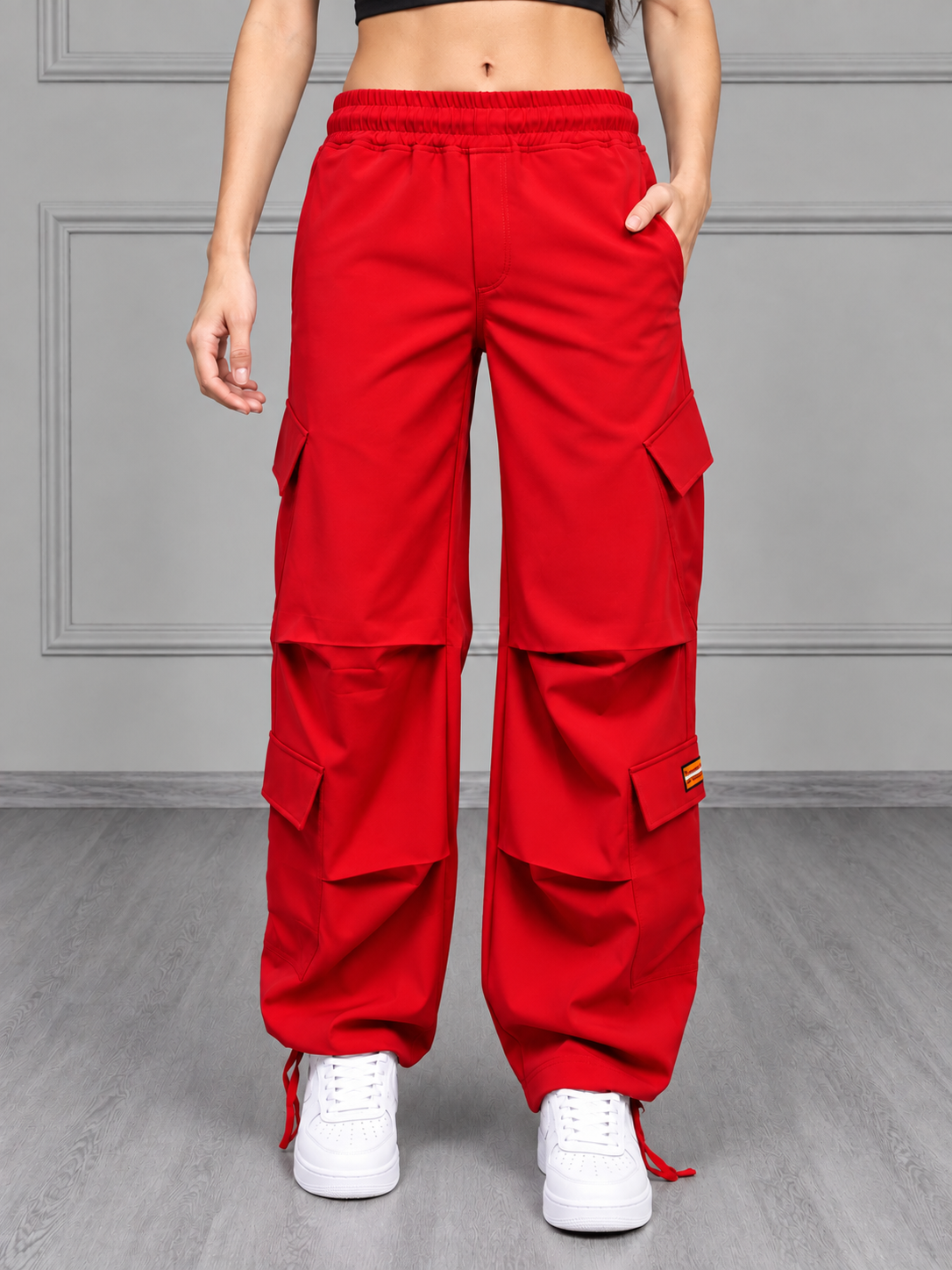 WOMEN TACTICAL FIT MULTI POCKET CARGO PANTS RED styled with white sneakers for bold streetwear look