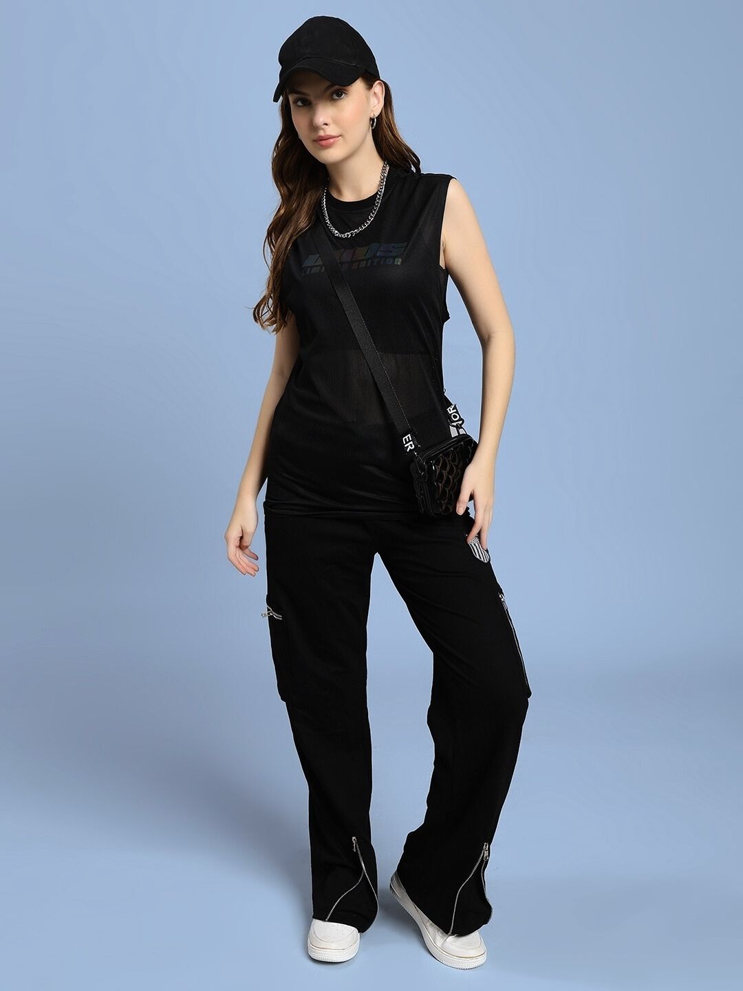 Model wearing WOMEN'S AIR-FLOW REGULAR FIT T-SHIRT BLACK with casual pants and accessories, showcasing comfort and style.