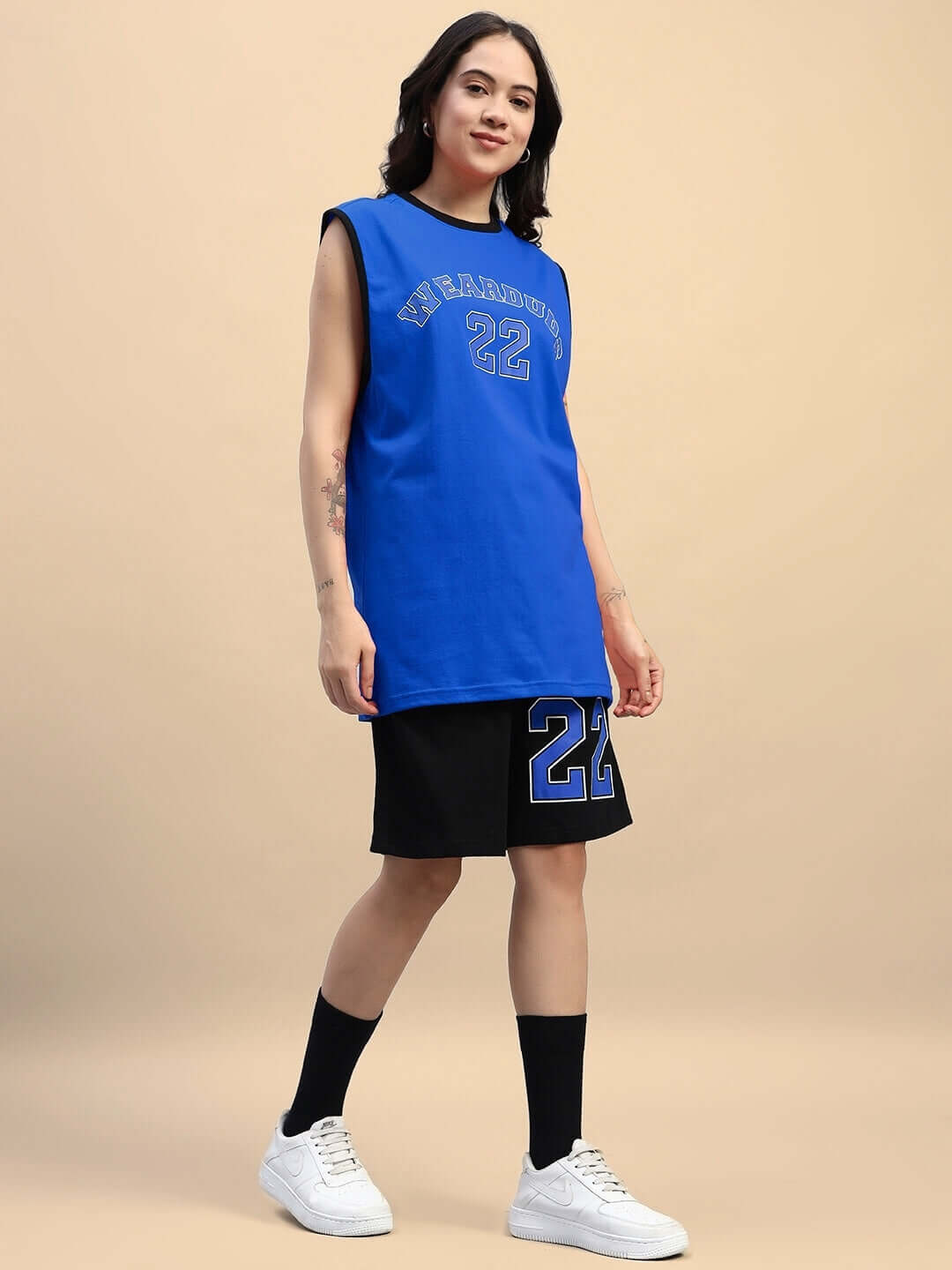 Model wearing Women's Amiga Gym Co-ord Set in Blue-Black, featuring a sleeveless top and shorts. Made from 100% cotton, perfect for casual wear.