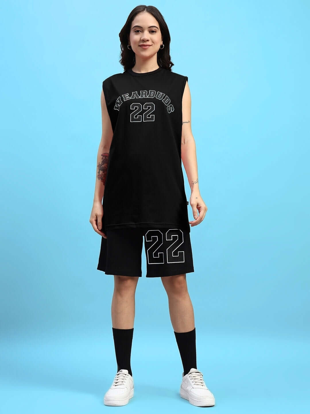 Woman wearing black WOMEN'S AMIGA GYM CO-ORD SET with '22' print, featuring a sleeveless top and shorts, ideal for workouts.