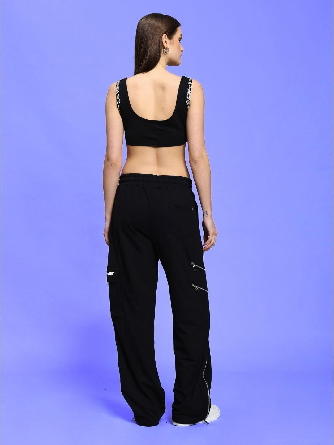 Model wearing WOMEN'S AMISHA CO-ORD SET in black, featuring relaxed fit joggers with drawstring waistband, showcasing back view.