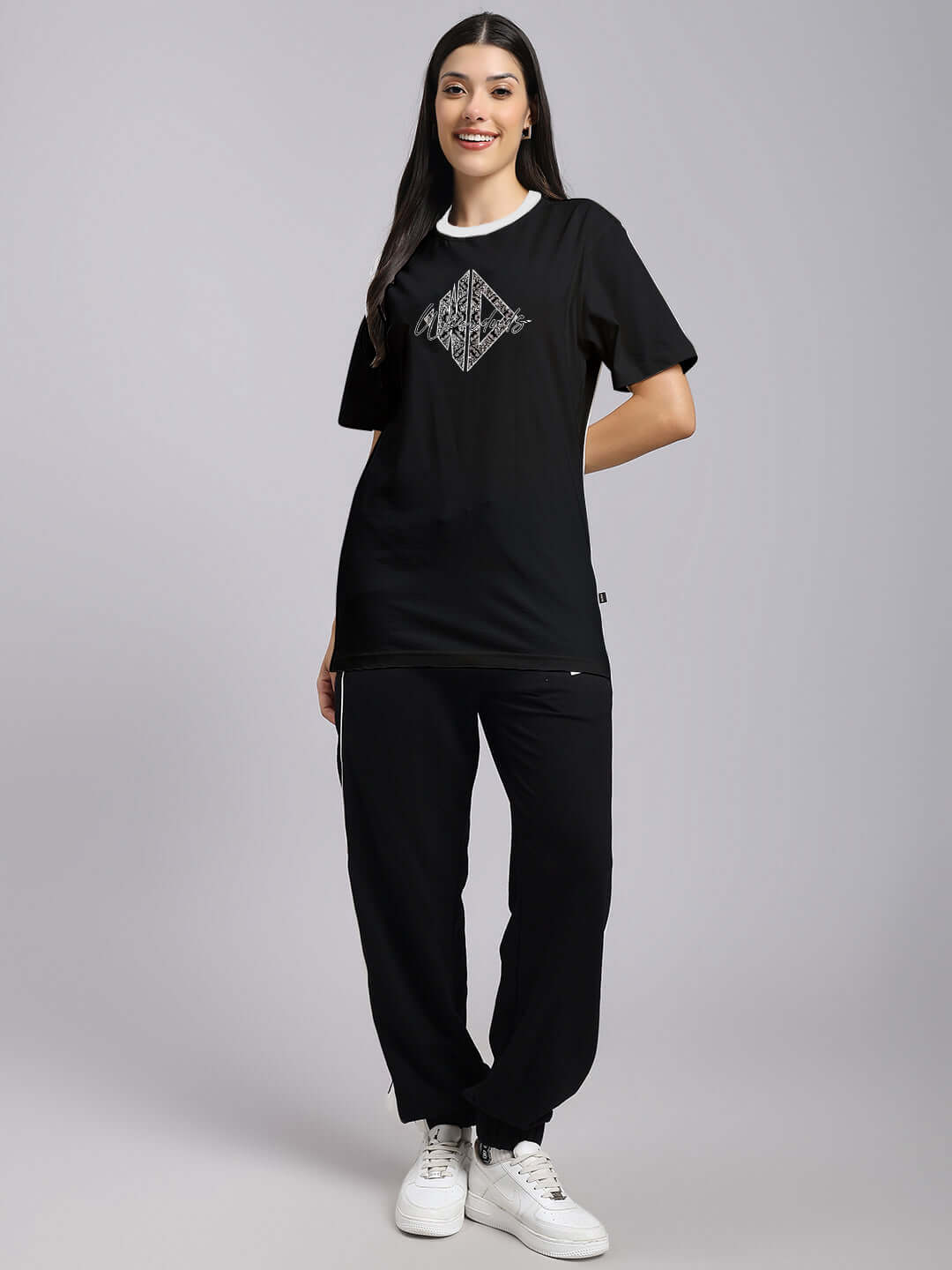 Model wearing WOMENS ANGULAR REGULAR FIT T-SHIRT BLACK with graphic design, casual style suitable for modern minimalism.
