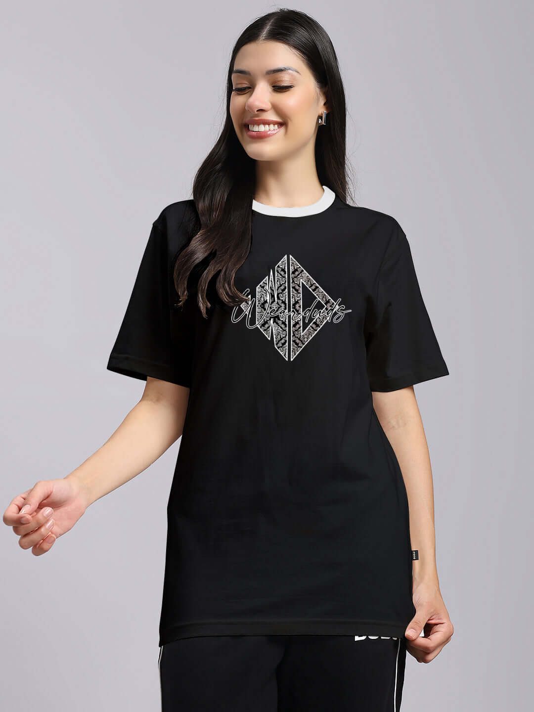 Black women's angular regular fit t-shirt with geometric design, model smiling, premium cotton, Color By Colours, Indian origin.