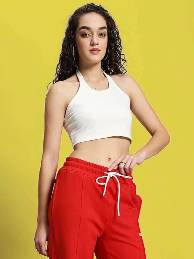 Off-white women's Anissa crop top in premium heavy gauge cotton, modeled against a yellow background, paired with red pants.