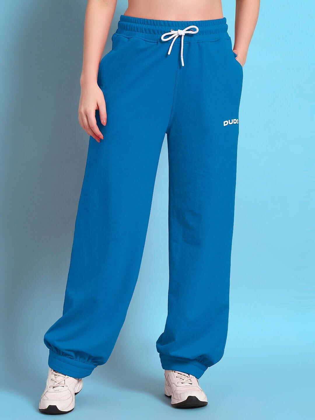 Women's blue relaxed-fit joggers by DUDS, showcasing comfortable elastic waist and custom fit option available for prepaid orders.