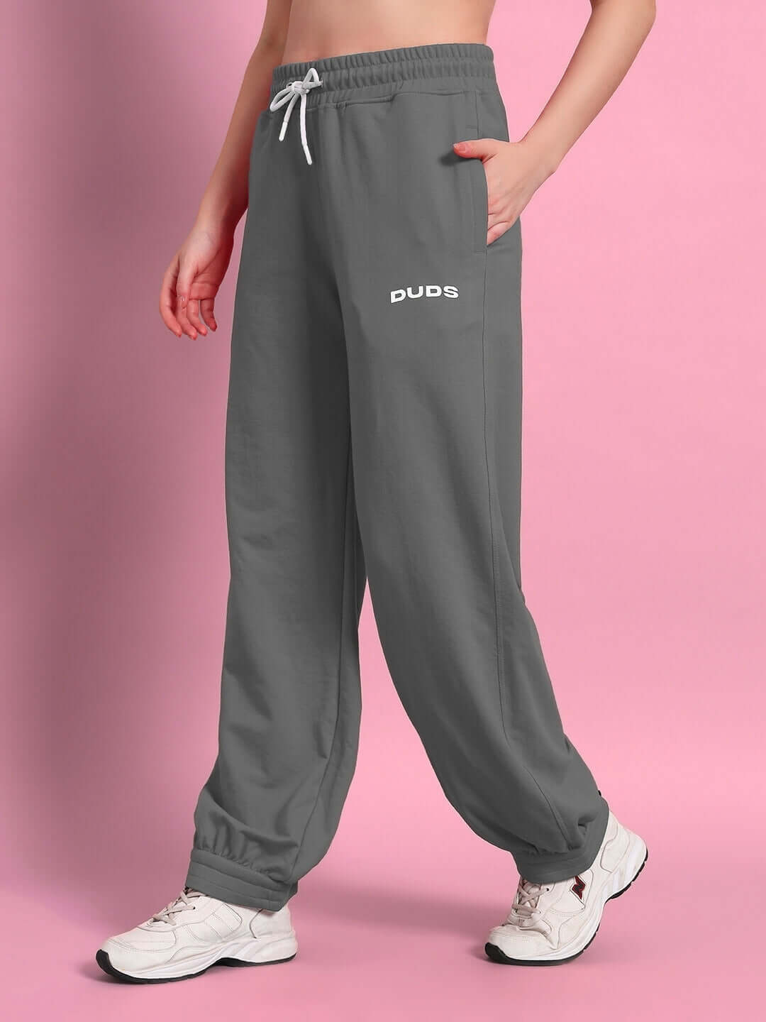 Woman wearing grey Austrian relaxed-fit joggers by DUDS, showcasing comfort and style.