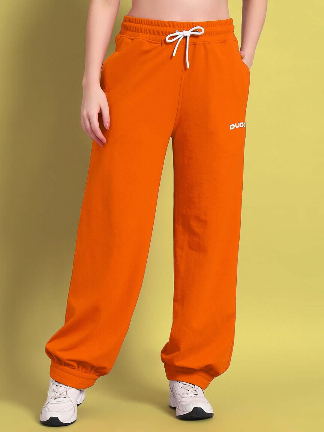 Woman wearing WOMEN'S AUSTRIAN RELAXED-FIT JOGGERS in orange, showcasing comfortable and stylish fit.