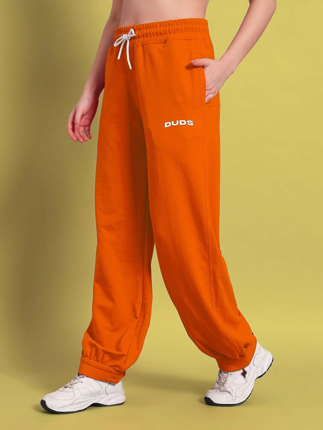 Women's orange Austrian relaxed-fit joggers by DUDS, featuring a comfortable waistband and made to order for a custom fit.
