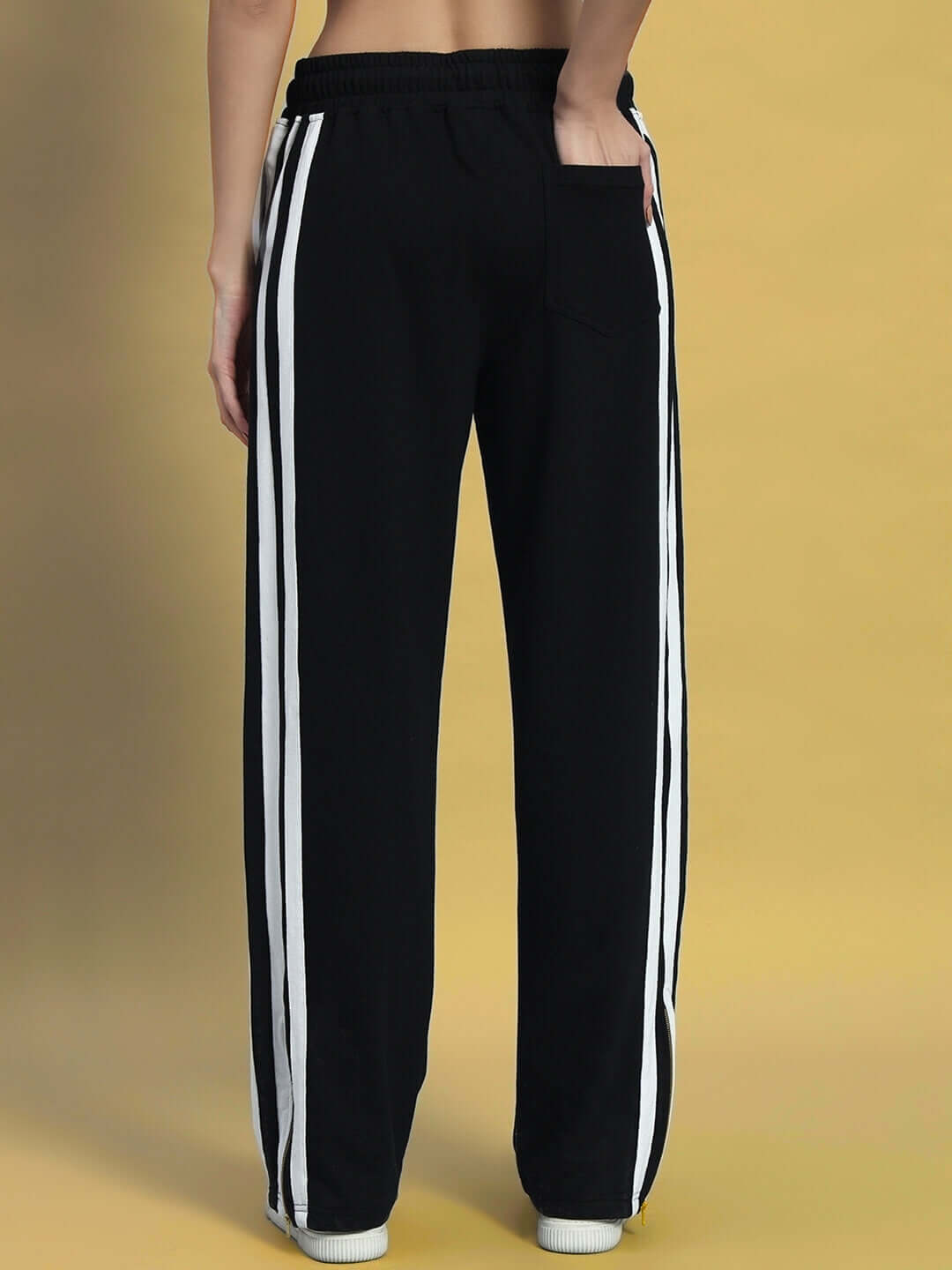 Back view of Women's Avalon Slit Zipper Joggers in black with white stripes, featuring a relaxed fit and comfortable waistband.