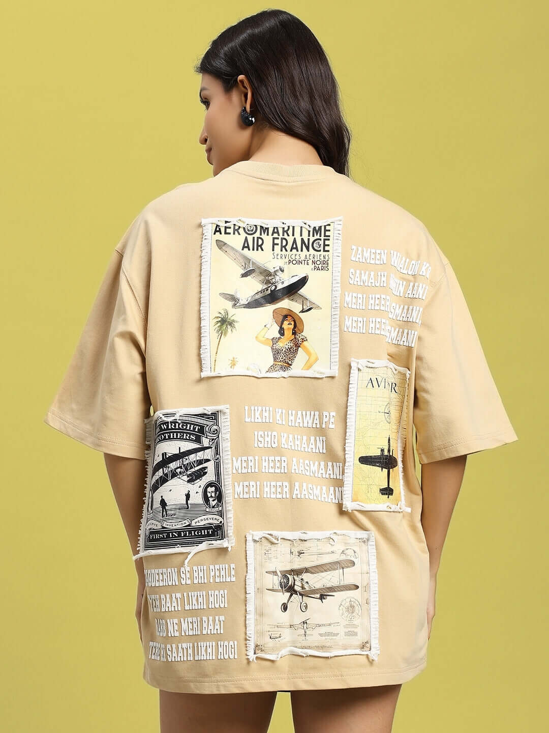 Back view of women's beige aviator oversized T-shirt, featuring vintage aviation-themed designs and text in stylish prints.