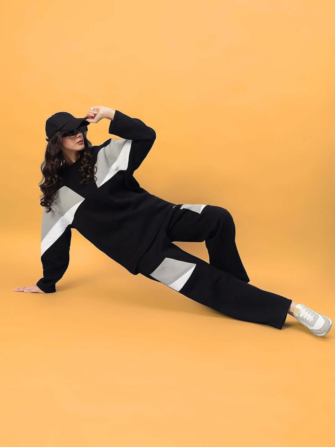 Women's aviator fleece colorblock co-ord in black, relaxed model pose on yellow background, stylish casual fashion outfit.