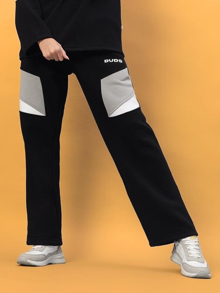 Model wearing WOMEN AVIATOR FLEECE CARGO PANT BLACK by WEAR DUDS, showcasing a blend of streetwear style and functionality.