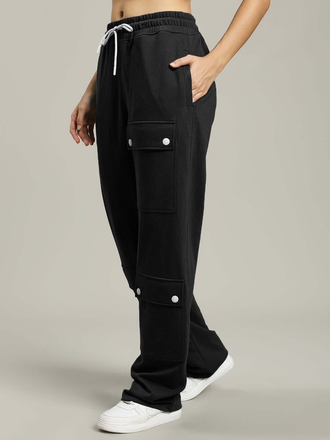 Women's black flap pocket baggy jogger pants with customizable fit option, shown in side view, featuring comfortable elastic waistband.